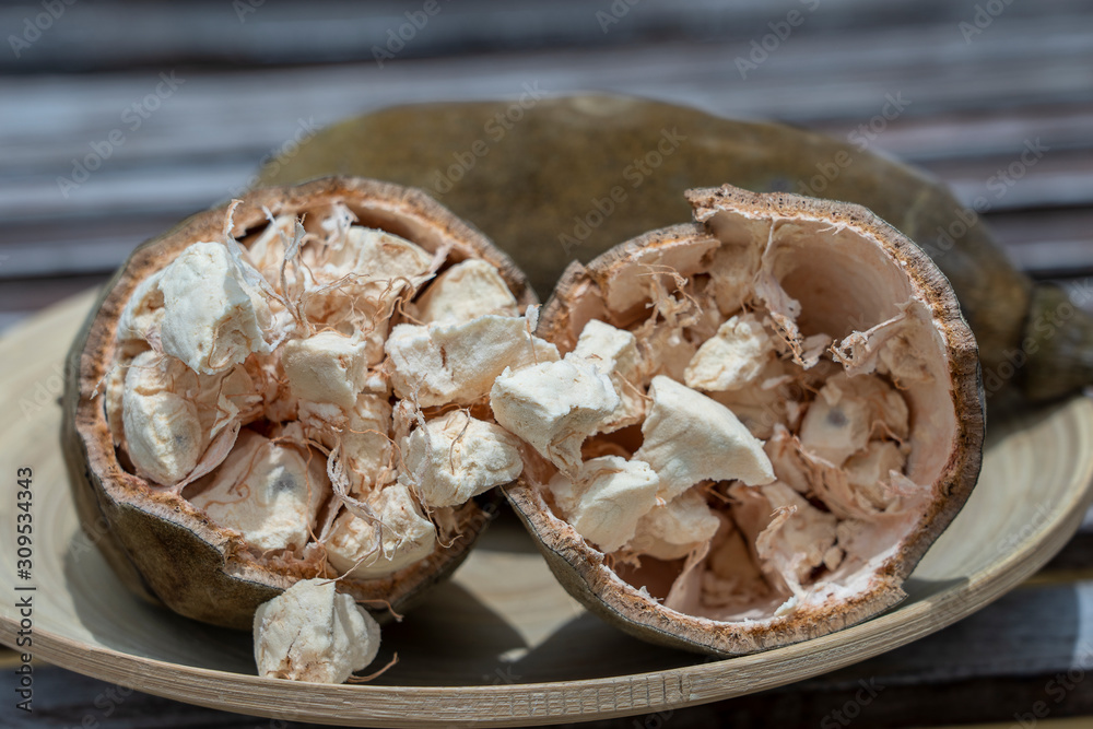 Baobab fruit or Adansonia digitata on plate, pulp and powder, superfood