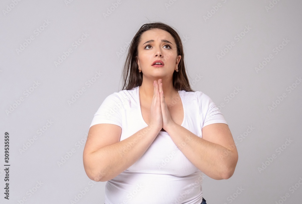 Plus Size Model with long hair posing in studio. be at one's de Plus Size Model with long hair posing in studio. be at one's de