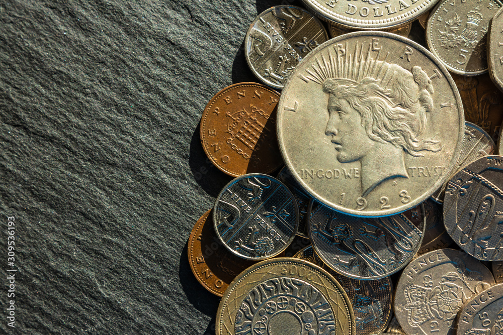 background. copper and silver coins of various denominations and values