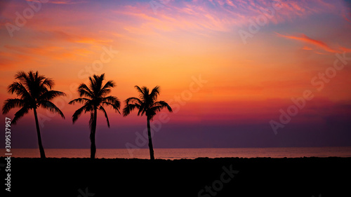 Silhouette Palm Trees By Sea Against Romantic Sky At Sunset