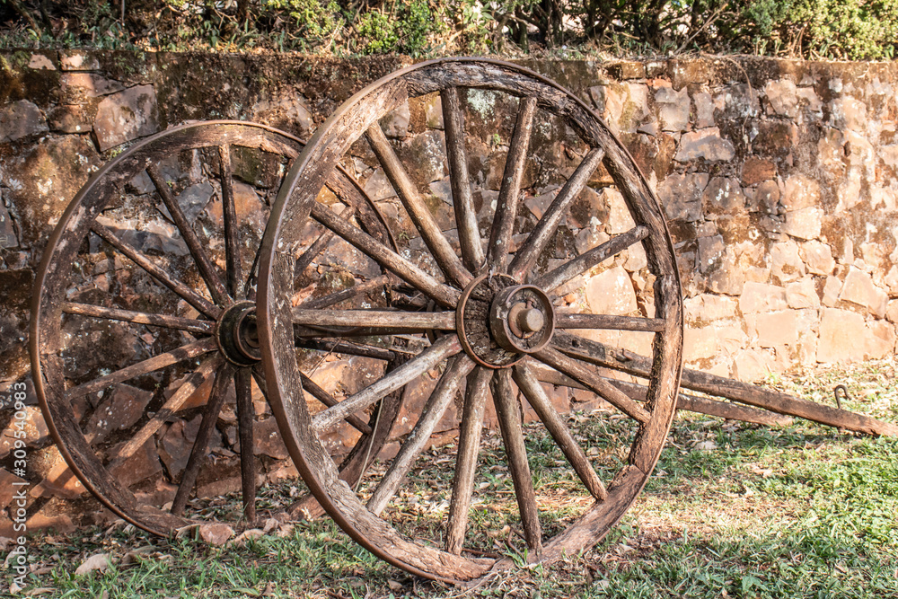 wagon wheel parking on grass with stone wall background in Brazil