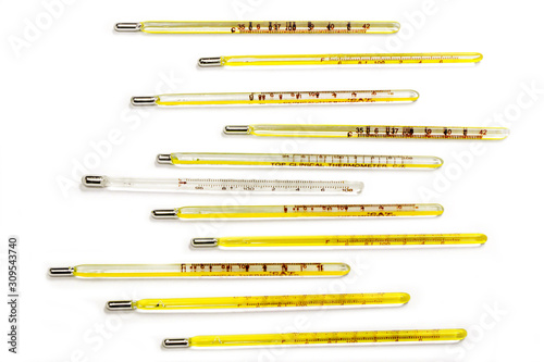 Closeup and top view small medical thermometers line up isolate on white background.