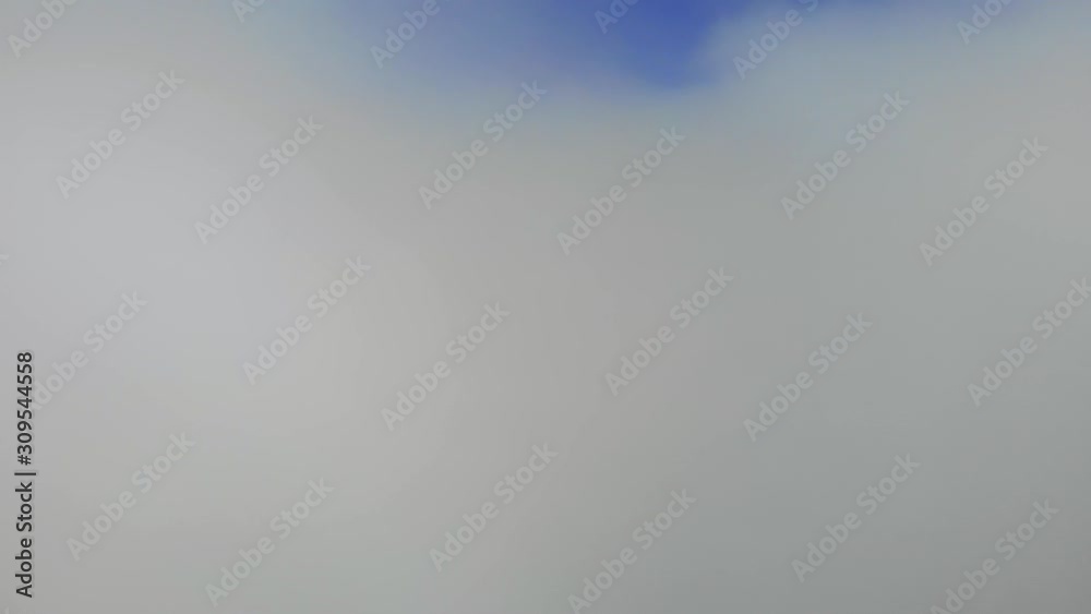 An incredible take-off from a white veil of fluffy clouds to a blue clear sky An incredible take-off from a white veil of fluffy clouds to a blue clear sky