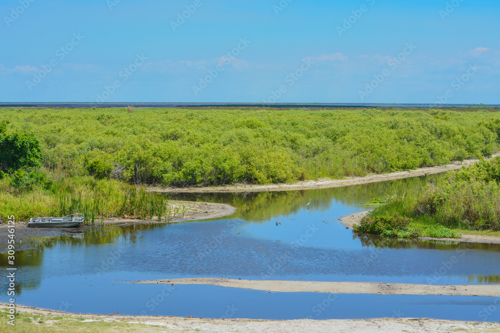 Abandoned boat in the marsh of Lake Okeechobee, Okeechobee County, Florida USA