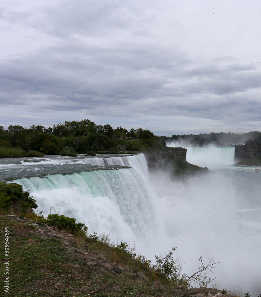 View of the Niagara Falls from the USA side and clouds in the background View of the Niagara Falls from the USA side and clouds in the background