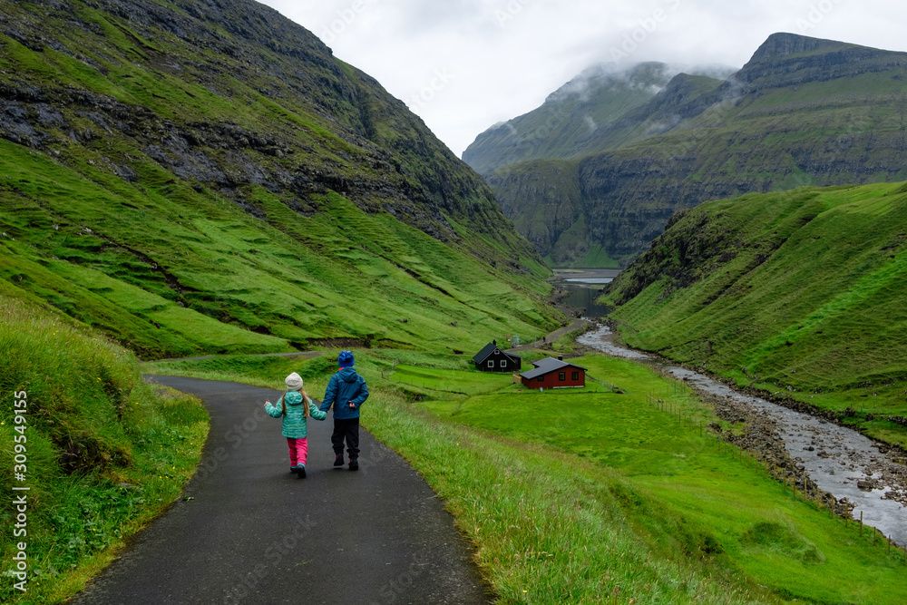 Children hiking in Saksun, Faroe Islands