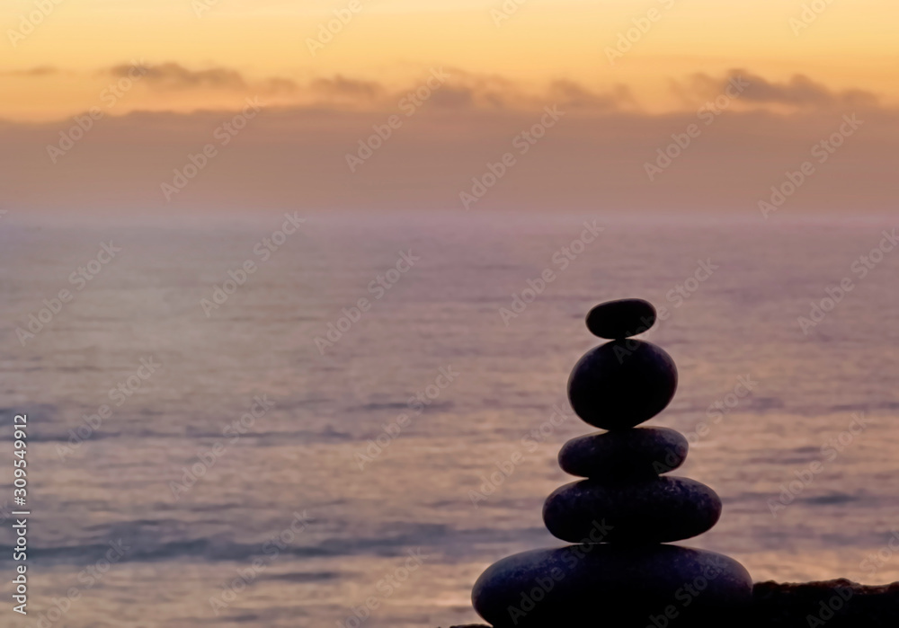 Stone Cairn At The Beach At Sunset