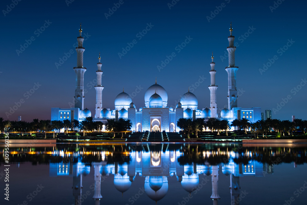 Grand Mosque reflected on the water in Abu Dhabi emirate of UAE