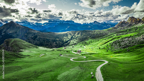 Winding road in Passo Giau and green Dolomites, aerial view