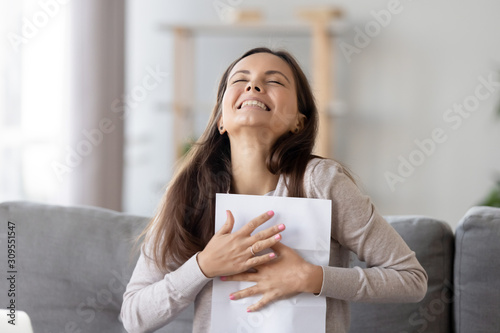 Excited girl feel euphoric receiving positive feedback letter