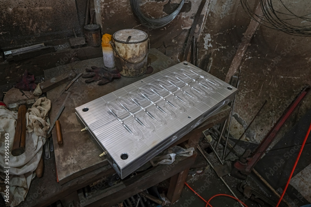 Fishing soft lure mold at factory. CNC machining of metal detail. Industrial milling cutting metalworking process. Fishing soft lure mold at factory. CNC machining of metal detail. Industrial milling cutting metalworking process.