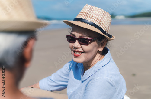 Asian couple senior elder retirement resting at beach honeymoon family together happiness people lifestyle