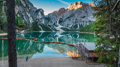 Llonely man at the Lago di Braies in Dolomites, Italy photo