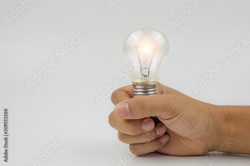 Light bulbs with bright light  in hand concetp for creativity, knowledge and organizational leadership.