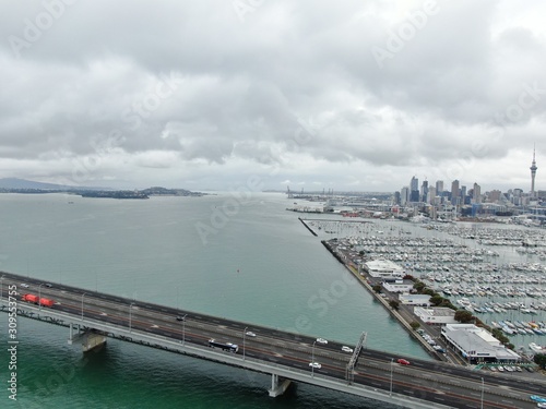 Viaduct Harbour, Auckland / New Zealand - December 14, 2019: The Amazing Auckland Harbour Bridge, and its surrounding marina bay, beaches, and the general cityscape of Auckland CBD