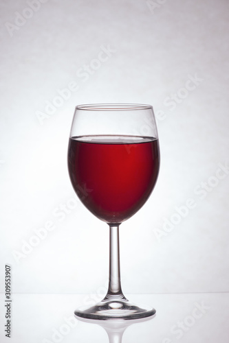 Glass of red wine on a light background