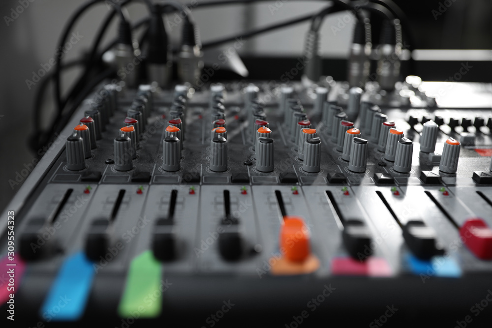 Modern audio mixing console, closeup. Music equipment