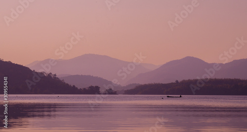 sunset or sunrise over river and mountain in Kanchanaburi Province, Thailand.