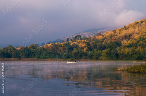 sunset or sunrise over river and mountain in Kanchanaburi Province, Thailand.
