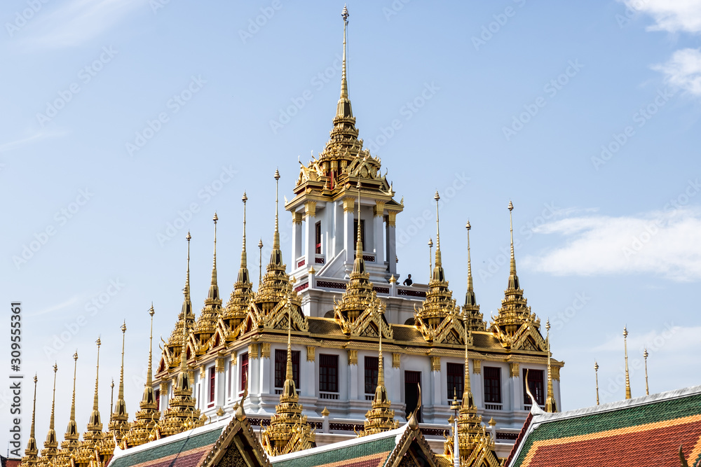 Fototapeta premium Temple roof in Bangkok Thailand. Blue sky blackgroud.