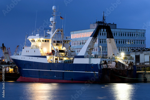 fishing vessel in port at nightfall