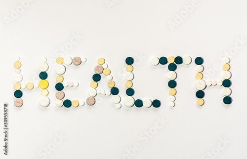 word health made from pills on a white background, healthcare concept.