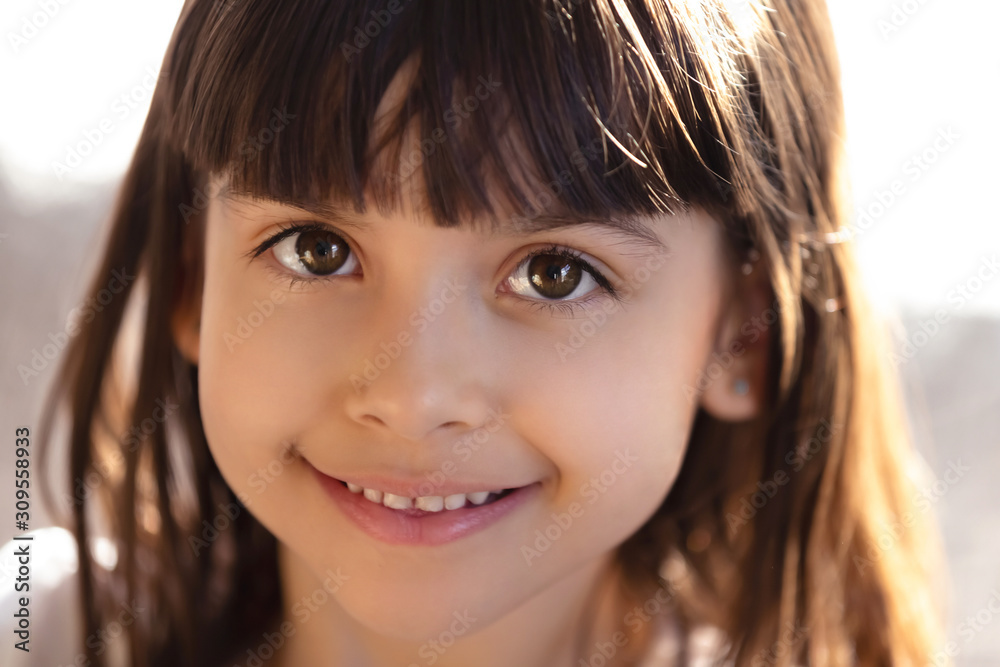 Head shot portrait of smiling little girl looking at camera Head shot portrait of smiling little girl looking at camera