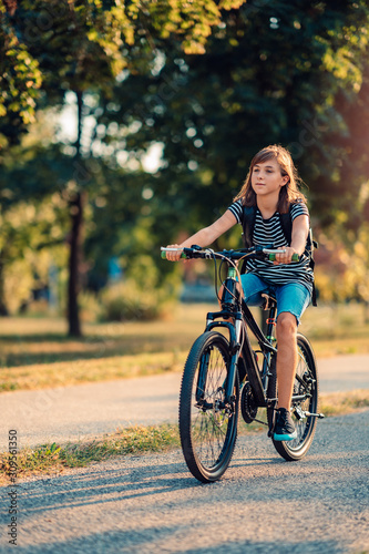 Girl Riding Her Bike To School