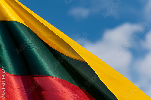 lithuania flag waving in the wind in front of blue sky