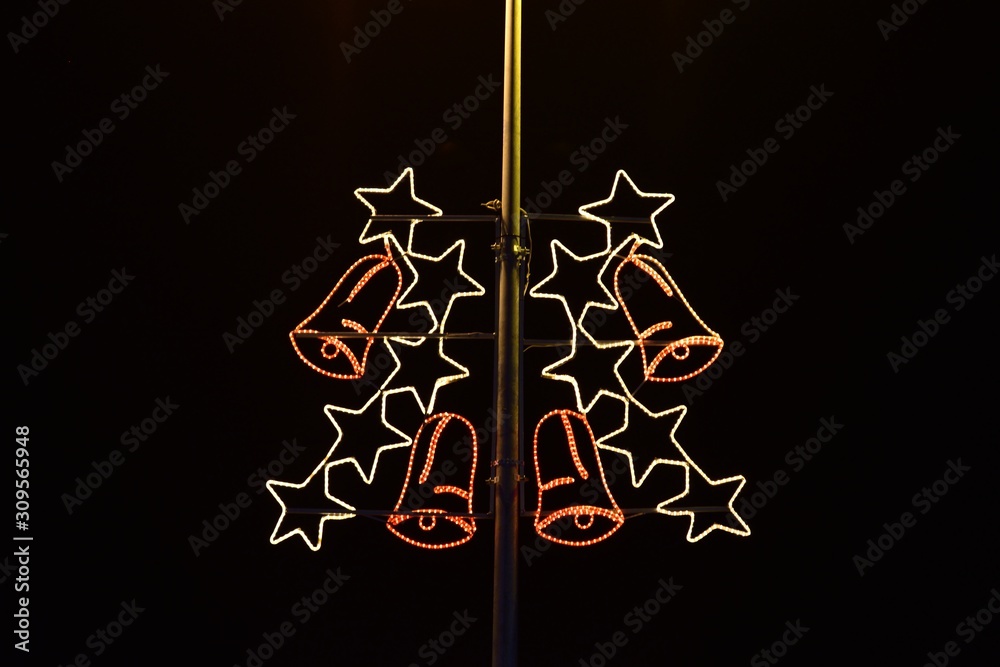 Fototapeta premium Image shows electric pillar embellished with Christmas stars and bells.