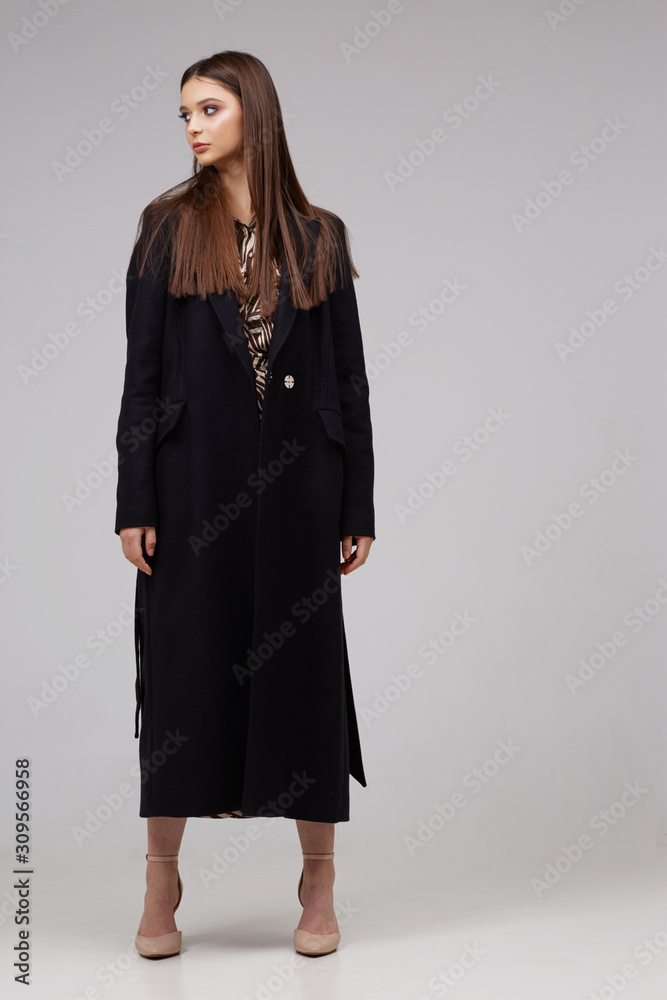 Young elegant woman in trendy black coat. Young elegant woman in trendy black coat.