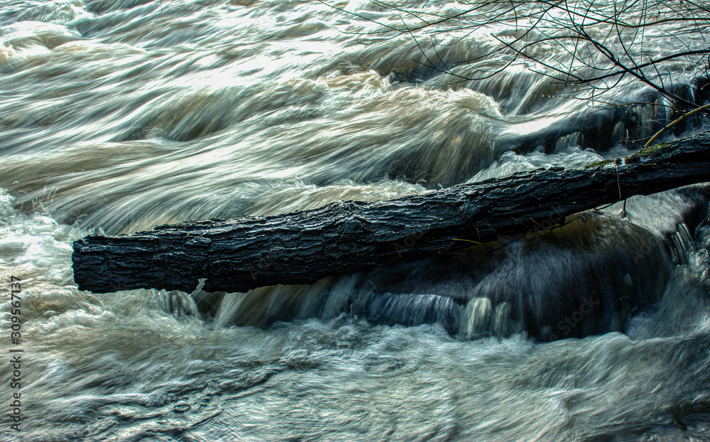 The River Aire, swollen by heavy rain, pours in a torrent over Hirst Mill  weir creating danger and energy Stock Photo | Adobe Stock