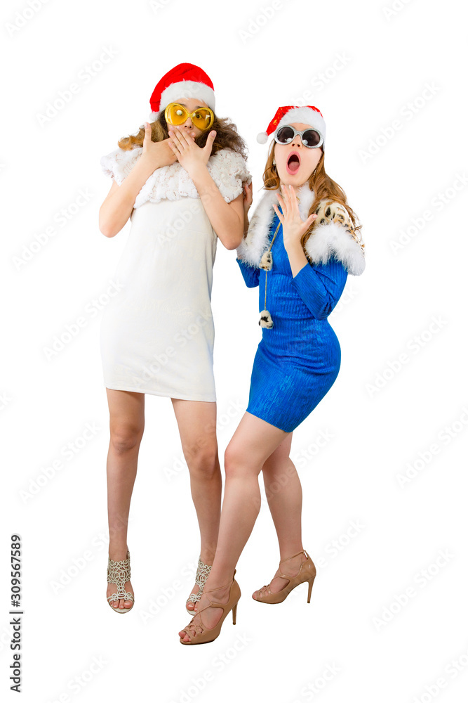 Wow. Portrait of two shocked amazed excited girlfriends in red santa hats. Isolated on white Wow. Portrait of two shocked amazed excited girlfriends in red santa hats. Isolated on white