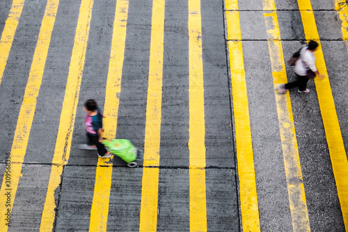 Photography two women crossing street on pedestrian crossing - motion blur