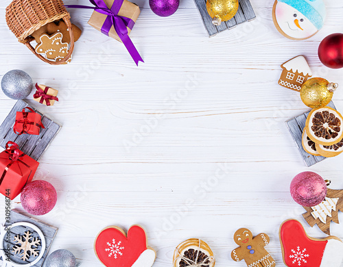Fototapeta Naklejka Na Ścianę i Meble -  Christmas background. Christmas gift, toys, gingerbread cookies, spices and decorations on wooden background. Top view