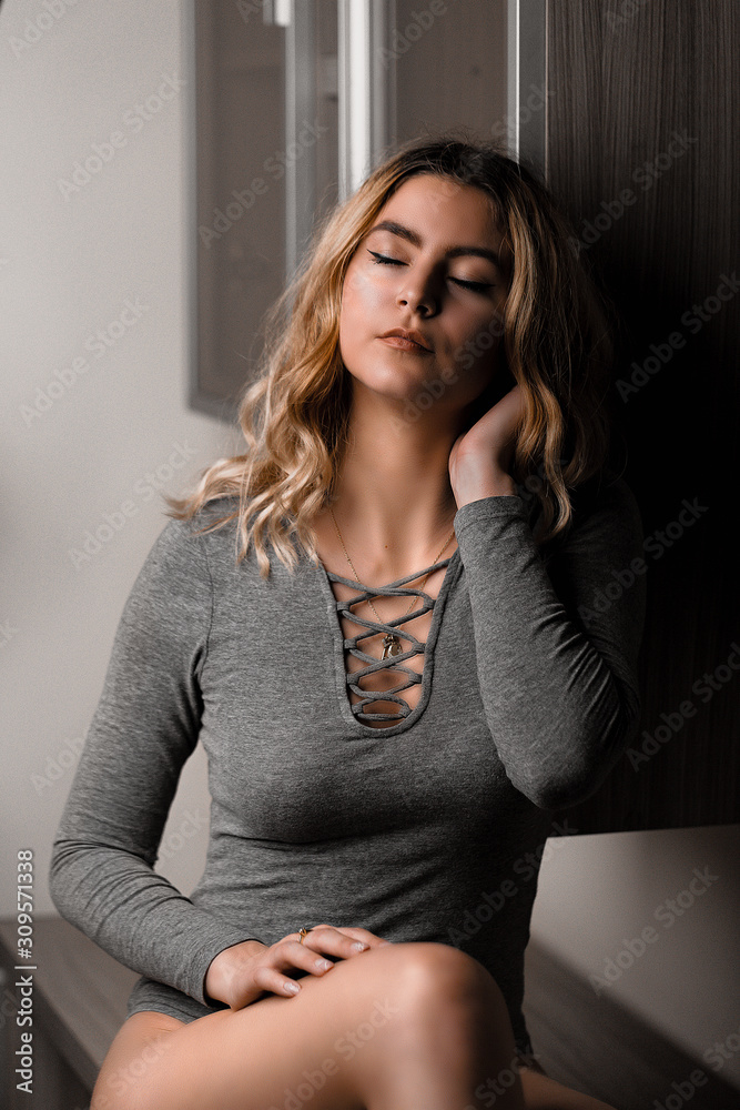Young beautiful blonde model posing in her room. Nice body, shiny pure skin, natural makeup, attractive look Young beautiful blonde model posing in her room. Nice body, shiny pure skin, natural makeup, attractive look