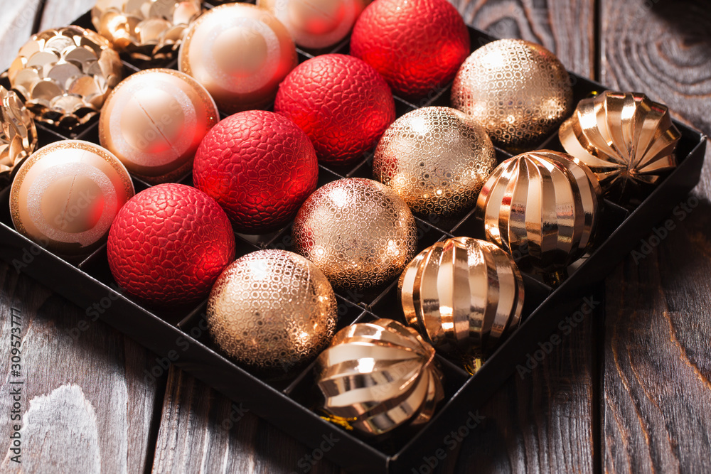 Christmas balls in box on dark wooden background Christmas balls in box on dark wooden background