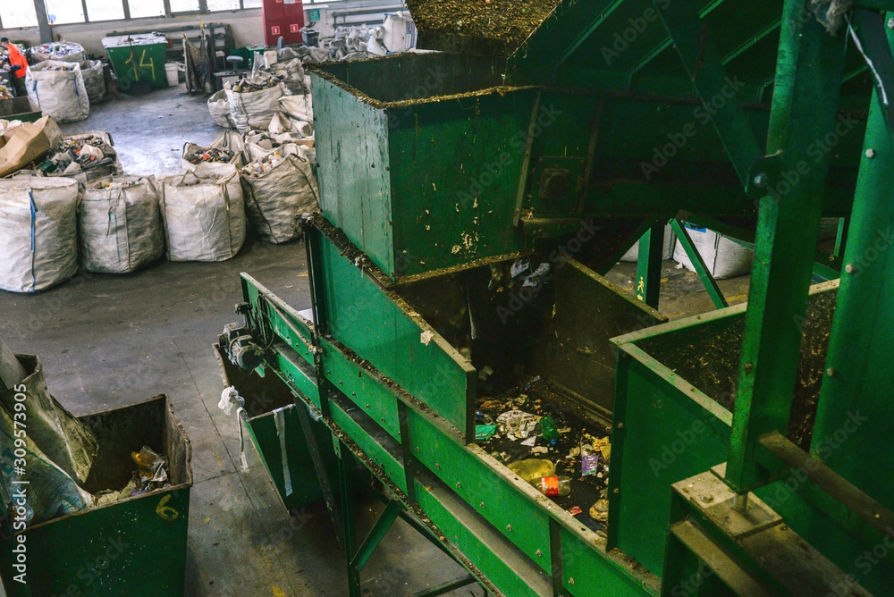 Conveyor belt at a garbage recycling plant. Equipment for waste sorting. The concept of waste management, management, reuse, recycling and recovery