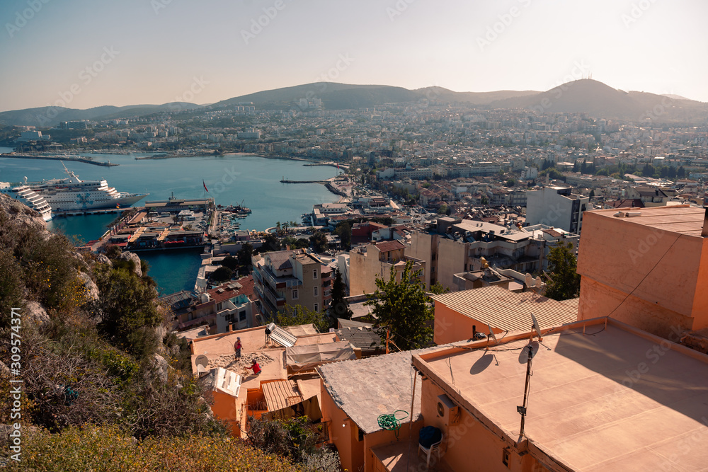 KUSADASI, TURKEY - APRIL 27, 2019: Casual view on the streets near Kusadasi city port side with buildings in sight