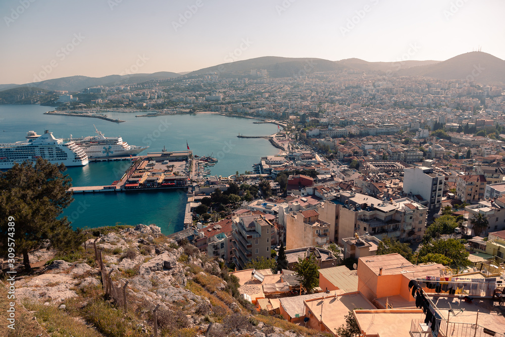 KUSADASI, TURKEY - APRIL 27, 2019: Casual view on the streets near Kusadasi city port side with buildings in sight