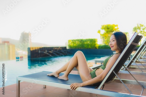 Beautiful young asian women happy smile relax around outdoor swimming pool in hotel resort for travel in holiday vacation