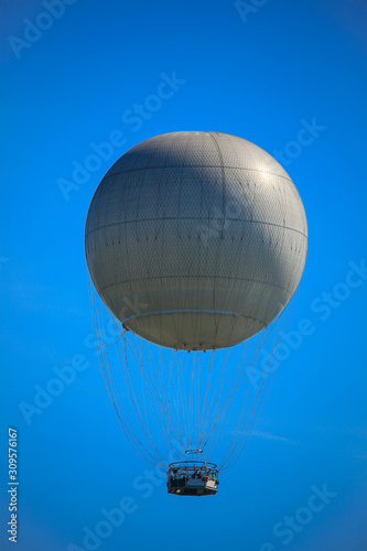 Hot air balloon trip against the background of blue sky.