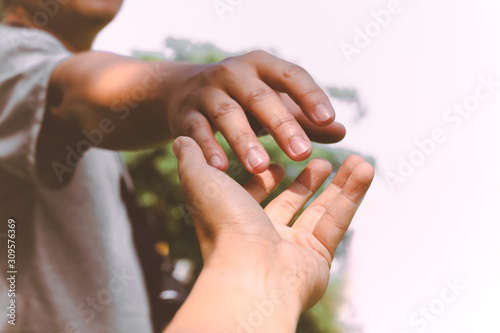 Help Concept hands reaching out to help each other.