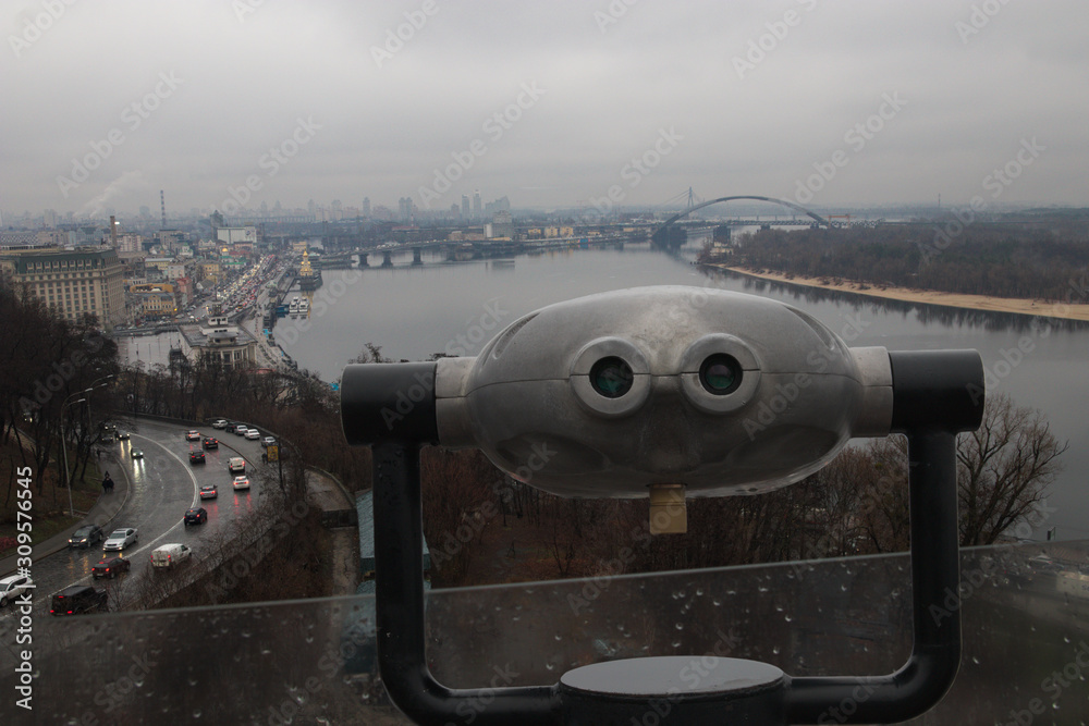 Binoculars on the viewpoint for viewing of the Dnieper River and Kiev city