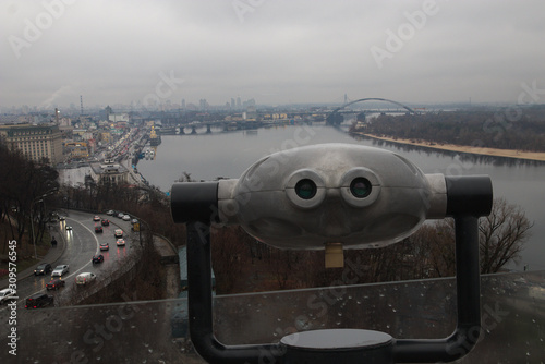 Binoculars on the viewpoint for viewing of the Dnieper River and Kiev city