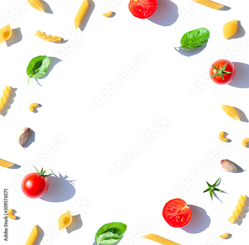 Italian pasta frame concept with tomatoes   fresh basil leaves and garlic. Food top view composition. Copy space