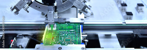 Technological process of soldering and assembly chip components on pcb board. Automated soldering machine inside at industrial,banner side photo