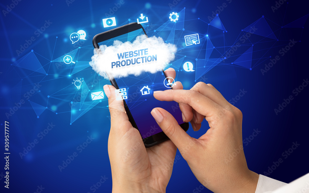 Female hand holding smartphone with WEBSITE PRODUCTION inscription, cloud technology concept Female hand holding smartphone with WEBSITE PRODUCTION inscription, cloud technology concept