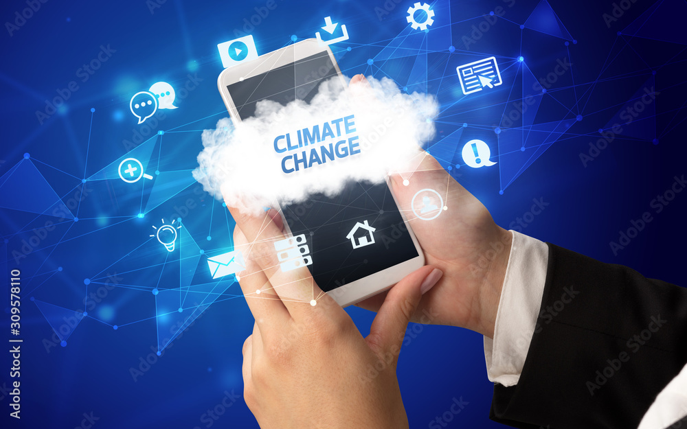 Female hand holding smartphone with CLIMATE CHANGE inscription, cloud technology concept Female hand holding smartphone with CLIMATE CHANGE inscription, cloud technology concept