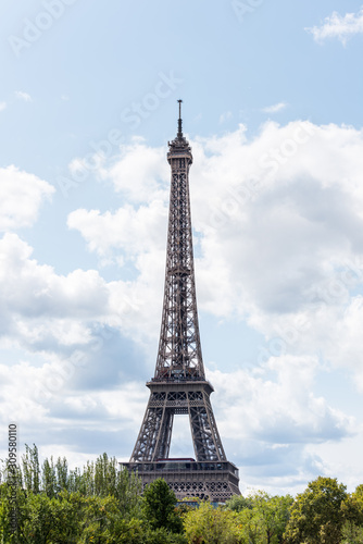 The Eiffel Tower against blue and cloudy sky, a wrought-iron lattice tower on the Champ de Mars in Paris, France, named after the engineer Gustave Eiffel, constructed from 1887 to 1889. © zz3701